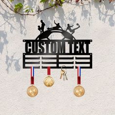 a metal sign that says custom text with two medals hanging from it