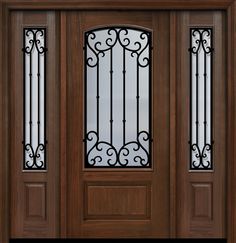 a wooden door with two glass panels and wrought iron bars