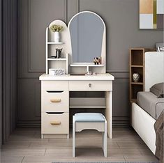 a bedroom scene with focus on the vanity and dressing table, along with a bed