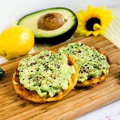 an avocado sandwich is sitting on a cutting board