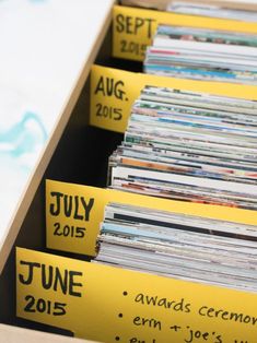 a box filled with lots of records sitting on top of a table next to each other