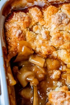 a casserole dish filled with apples and crumbled toppings is shown