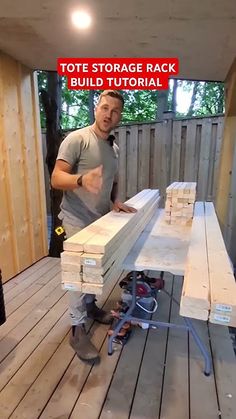 a man standing next to a pile of wooden planks