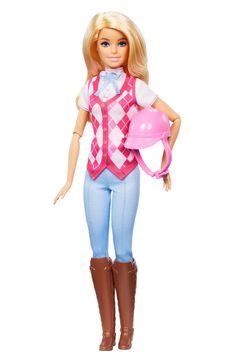 a barbie doll with a pink outfit and brown boots, holding a pink hat in her hand