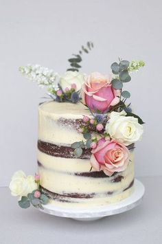 a white and brown cake with flowers on top