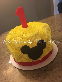 a mickey mouse cake with the number one on it