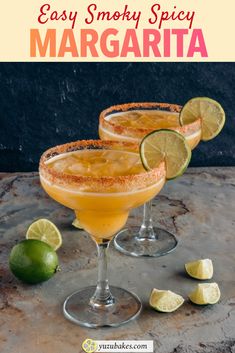 two margarita cocktails with lime slices on the rim and garnished in salt