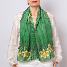 "Designer: Liga Kandele Material: 100% silk  fabric Colour: green and yellow. Size:  14.1\" X 53.5\"  ( 36 cm X  135 cm) Gift wrapped This green silk scarf is personally hand painted scarf by me and it's unique piece of art to wear.  I am professional silk painting artist with many years of experience. My studio is located in beautiful place near the Adriatic sea in Albania. This multi-purpose daffodils print scarf can be used to make any outfit stand out. There are so many ways to wear it like scarf or shawl, top, belt, bag scarf, hair scarf or head scarf, bandana or turban. Let your imagination fly. It can be perfect mindfulness gift for your loved ones. Great mother in law gift, daughter in law gift, gift for mom, aunt gift, 60th birthday gift, 50th birthday gift for women, cotton anniv Green Silk Scarf For Formal Occasions, Gold Silk Scarf For Spring, Formal Green Silk Scarf, Yellow Silk Scarf For Spring Gift, Yellow Silk Scarf For Spring, Personalized Scarves, 50th Birthday Gifts For Woman, Green Silk Scarf, Spring Scarf