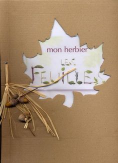 a piece of cardboard with the words mon herbe on it and some dry leaves