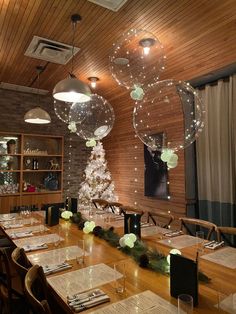 an empty dining room is decorated for christmas with balloons in the shape of stars and snowflakes