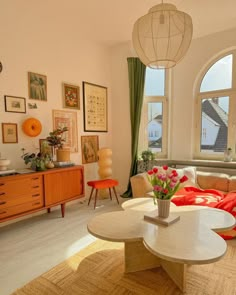 a living room filled with furniture next to a large window covered in lots of windows