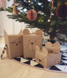 some brown paper bags sitting next to a christmas tree