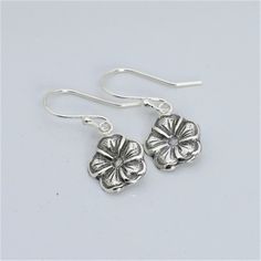 Artisan handmade sterling silver earrings with antiqued finish. Forget me not flower is a symbol of remembrance of a loved one lost. It also symbolizes fidelity, truthfulness, respect and true love. Perfect gift for any woman on her birthday, Mother's Day, anniversary, Christmas holidays, etc. * Dangle length approximately 1 inch * Handcrafted from sheet metal with steel die reproductions and hydraulic press * Antiqued Finish .925 Sterling Silver * Boxed in simple Kraft cotton filled box with ri Sterling Silver Flower Charm Earrings As Gift, Sterling Silver Flower Charm Earrings For Anniversary, Sterling Silver Dangle Flower Earrings For Gifts, Nickel-free Sterling Silver Teardrop Flower Earrings, Handmade Sterling Silver Flower Earrings, Sterling Silver Flower Pendant Earrings As Gift, Silver Sterling Flower Pendant Earrings, Handmade Sterling Silver Flower Drop Earrings, Handmade Sterling Silver Drop Flower Earrings