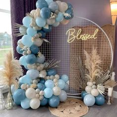 a balloon arch is decorated with blue and white balloons