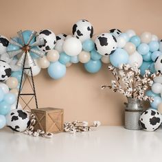 a table topped with balloons and other decorations