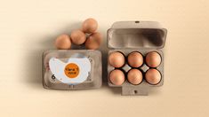 an egg carton with six eggs in it next to a dozen ones on a table