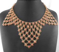 We are pleased to present for your consideration, this beautiful Art Deco vintage Egyptian style Cleopatra necklace.  Book piece described in "1840-1940 Popular Jewelry" by Roseann Ettinger. Made of yellow gold tone metal, decorated with imitation red coral cabochons. Measures: 16" x 3 1/4" (40 x 8.0 cm) Missing one small cabochon near closure at back. Otherwise, in very good vintage condition. Look at photos for more details. Will look great when worn or in collection ! Cleopatra Necklace, Egyptian Style, Book Pieces, Egyptian Revival, Coral And Gold, Bib Necklaces, Deco Vintage, Popular Jewelry, Gold Tone Necklace