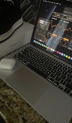 an open laptop computer sitting on top of a desk next to a mouse and keyboard