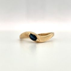 Natural Blue Sapphire set in 14K yellow gold. This is a beautiful blue with a great sparkle in the sunlight. A simple elegant twist look to stack with other rings or worn on it's own. Size 8.5 14K yellow gold Weight: 1.93 grams Blue Marquise cut Sapphire approximately .20ct ***With any pre-owned/Vintage/Antique items, it is common to have some wear, As we inspect each piece of our jewelry, we make sure the wear and tear is acceptable within industry standards*** FOLLOW US TO SEE MORE PHOTOS OF O Stackable Marquise 14k Gold Rings, Blue Sapphire Stackable Ring In 14k Gold, Stackable Blue Sapphire Ring In 14k Gold, Stackable 14k Gold Blue Sapphire Ring, Blue 14k Gold Stackable Rings, 14k Gold Blue Diamond Ring, Blue 14k Gold Ring Stamped 14k, Blue Solitaire Birthstone Ring In 14k Gold, Classic Stackable Sapphire Rings In Yellow Gold