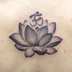 a lotus tattoo on the back of a woman