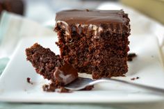 a piece of chocolate cake on a plate with a fork