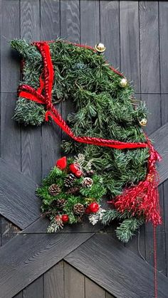 a christmas wreath on top of a wooden fence