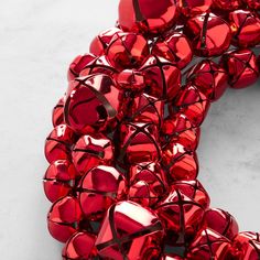 a bunch of shiny red hearts on a white surface