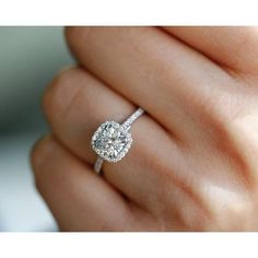 a woman's hand with a diamond ring on it