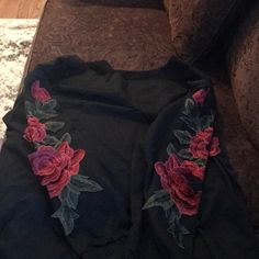 Black T Shirt With Distressing And Flower Embroidered Patches On Sleeves. Never Worn! Black Tops With Embroidered Graphics For Fall, Black Long Sleeve Embroidered T-shirt, Black Embroidered Tops For Fall, Black Embroidered Crew Neck Top, Black Floral Embroidery Crew Neck T-shirt, Embroidered Black T-shirt For Spring, Embroidered Black T-shirt For Fall, Black Embroidered T-shirt For Fall, Black Embroidered T-shirt For Spring