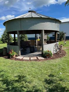 an outdoor gazebo sitting on top of a lush green field