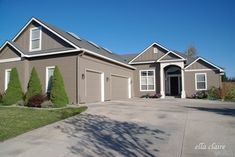 a large house with two car garages in the driveway