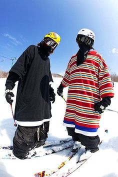 two people standing on skis in the snow