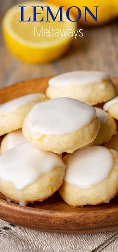 lemon cookies with white icing on a wooden plate