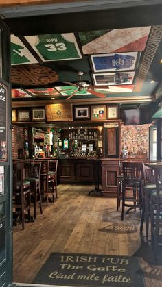 the inside of a pub with wooden tables and chairs