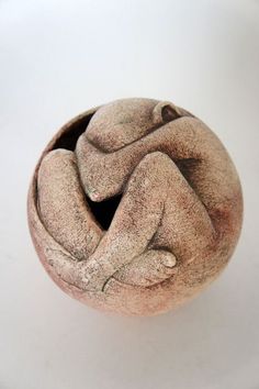 a clay sculpture sitting on top of a white table