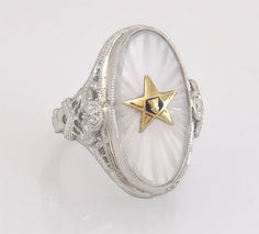 ~ Up for sale is an estate 14K Gold Order of the Eastern Star masonic children's ring! ~ This children's ring has one 17 x 8.5 mm camphor glass piece with the classic symbol of the Order of the Eastern Star! Glass has fine hand carved lines in the back of the stone for a gorgeous star burst pattern! ~ Order of the Eastern Star was established in 1850 by Rob Morris, a noted Freemason! ~ Genuine antique piece with classic Art Deco characteristics! This ring has such beautiful detail it must be cus White Oval Engraved Hallmarked Ring, White Star Of David Jewelry For Anniversary, Heirloom White Engraved Oval Ring, Heirloom White Oval Engraved Ring, White 14k Stamped Art Deco Rings, White 14k Stamped Round Signet Ring, Collectible White Cabochon Rings, White Art Deco Collectible Ring, Victorian White Cabochon Rings