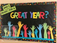 a bulletin board with colorful hands and the words, who's ready for a great year?