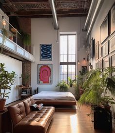 a living room filled with furniture and lots of plants on the wall next to a bed