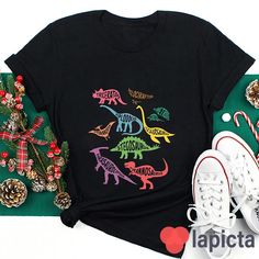 ✔️ TITTLE : Meet Dinosaurs With Me Teacher T-Shirt, Dinosaur Shirt, Dinosaur Lover Shirt, Kindergarten Shirt, Teacher Shirt, Gift For Teacher ✔️ IMPORTANT: Both Men and Women can we our shirts because this is unisex style t-shirts; Wash item inside out in cold water, do not bleach, do not dry clean, do not iron directly on the design. ✔️ MATERIAL DETAILS: 5.3-ounce, 100% cotton (99/1 cotton/poly (Ash) & 90/10 cotton/poly (Sport Grey); Heavyweight classic unisex tee; Taped neck and shoulders; Tea Fun Short Sleeve Tops With Dinosaur Print, Black Dinosaur Print Short Sleeve T-shirt, Black Short Sleeve T-shirt With Dinosaur Print, Black Dinosaur Print Crew Neck Top, Casual Dinosaur Print Cotton T-shirt, Kindergarten Shirts, Dinosaur Shirt, Tee Shirt Designs, Gift For Teacher