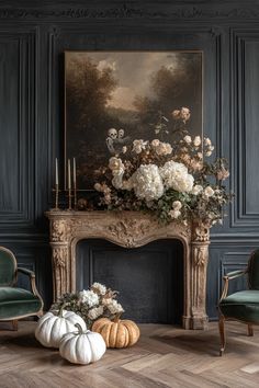 an ornate fireplace mantel with white flowers and pumpkins