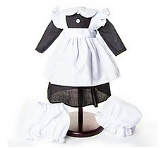 a white and black dress on a stand with clothes around it's neckline