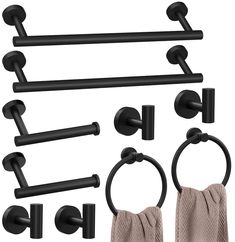 an assortment of black bathroom accessories including towel rings, toilet paper holders and towels ring