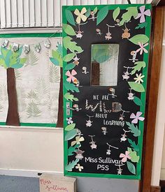 a classroom door decorated with flowers and leaves