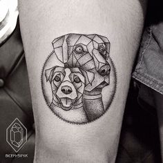 a black and white photo of two dogs in a circle tattoo on the right thigh