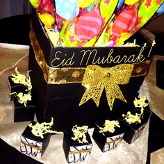 a birthday cake with balloons and confetti on it that says eid mubarak