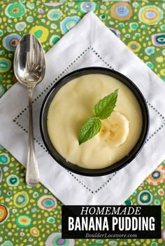 a bowl of banana pudding on top of a napkin next to a spoon and fork