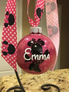 a pink ornament with minnie mouse on it