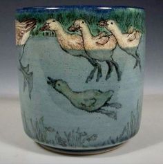 a ceramic cup with ducks on the water