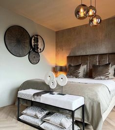 a large bed sitting next to two lamps on top of a wooden floor