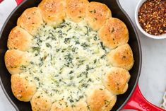 a skillet filled with cheese and spinach bread